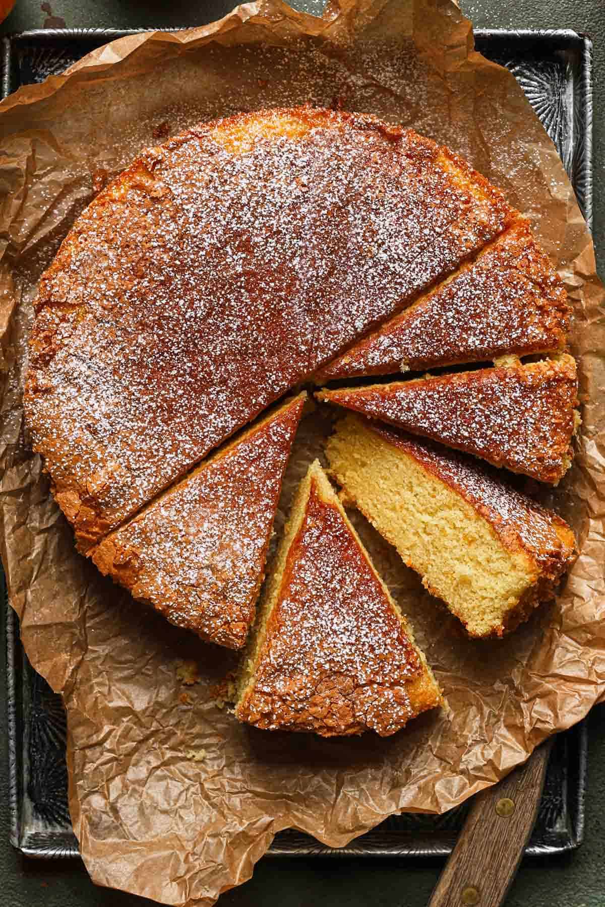 Sicilian whole orange cake over parchment paper, sliced.