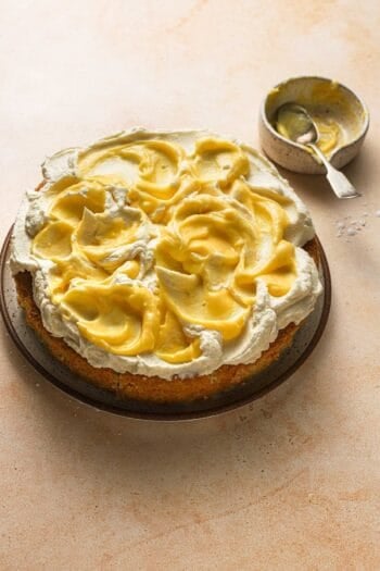 a limoncello cake topped with mascarpone frosting and lemon curd.