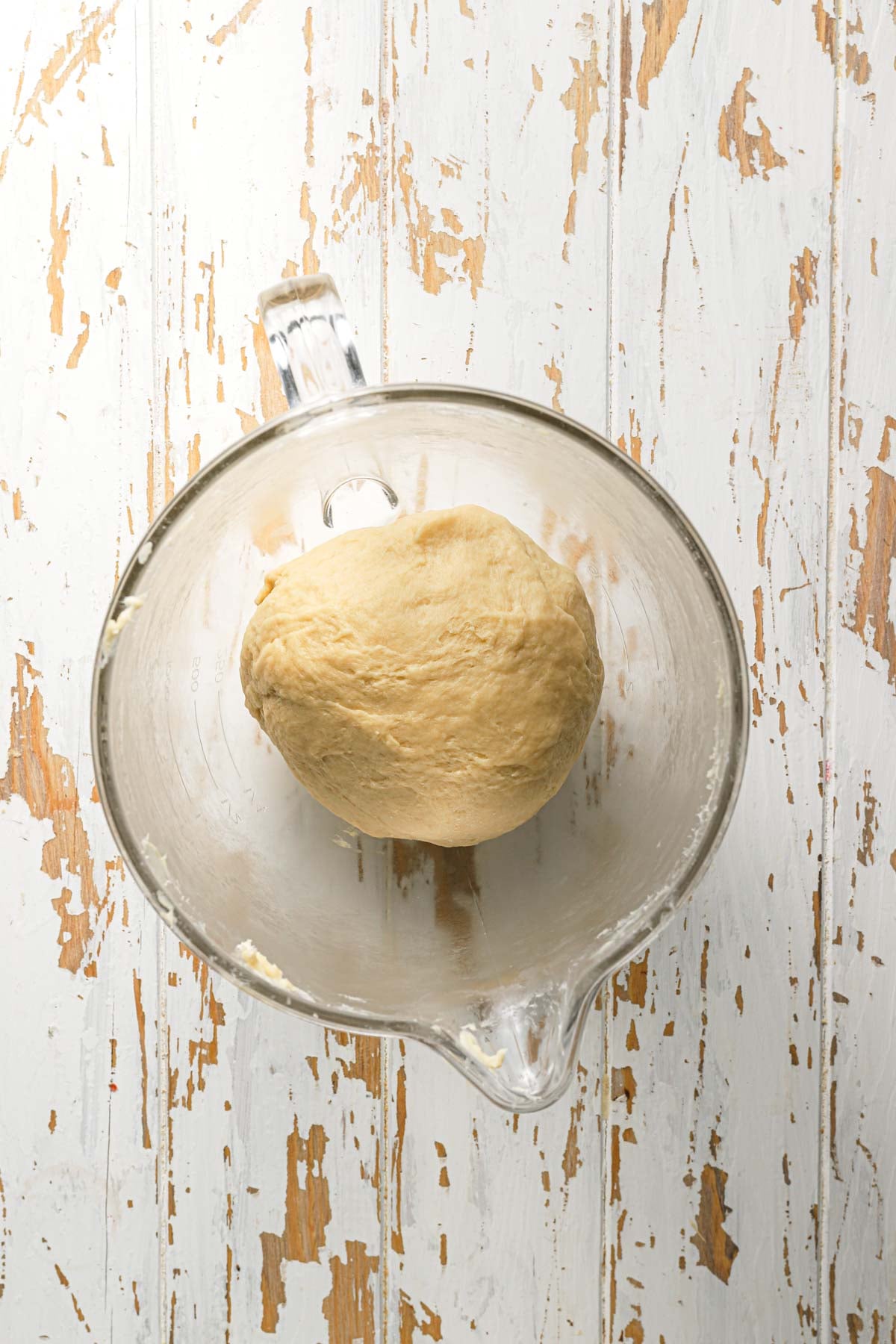A mixer bowl with dough.