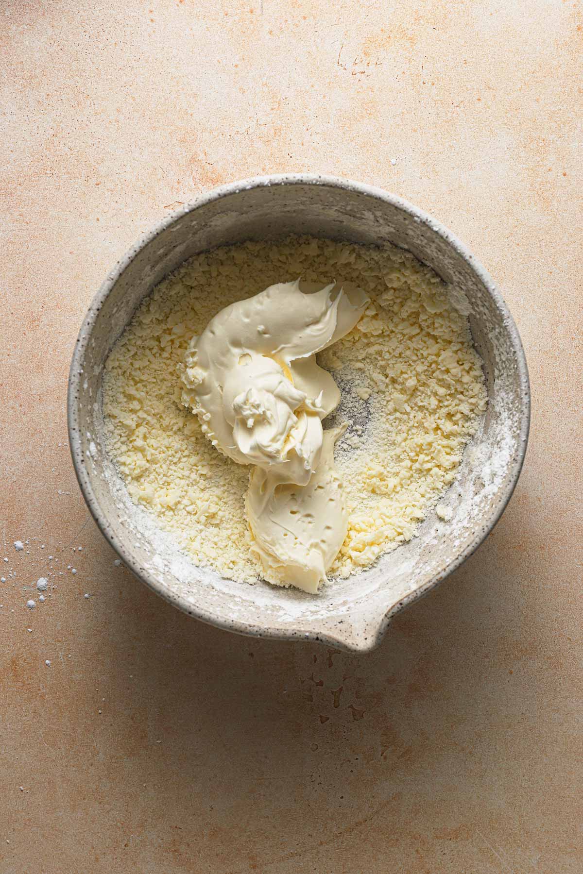 A bowl with creamed butter and a dollop of mascarpone cheese.