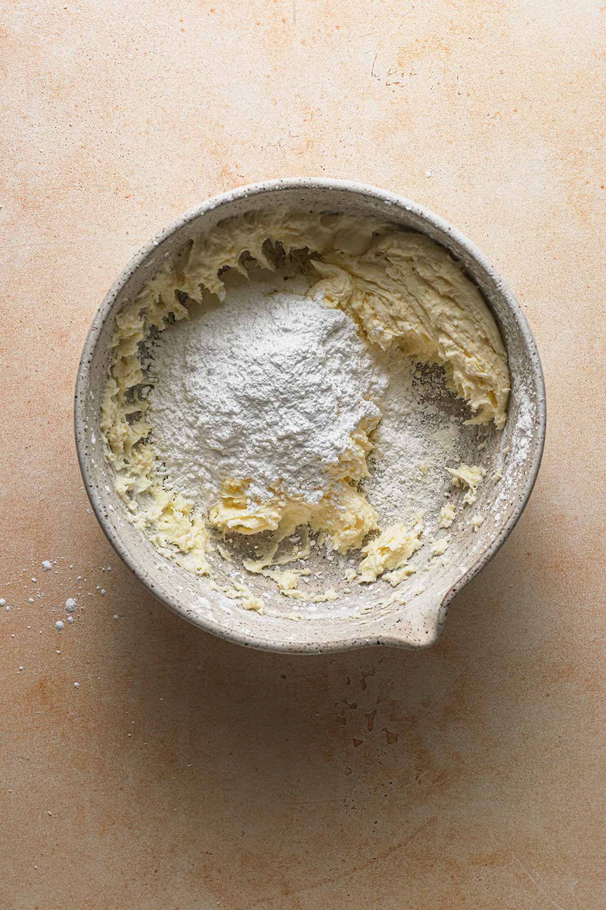 A bowl with creamed mascarpone and powdered sugar. 