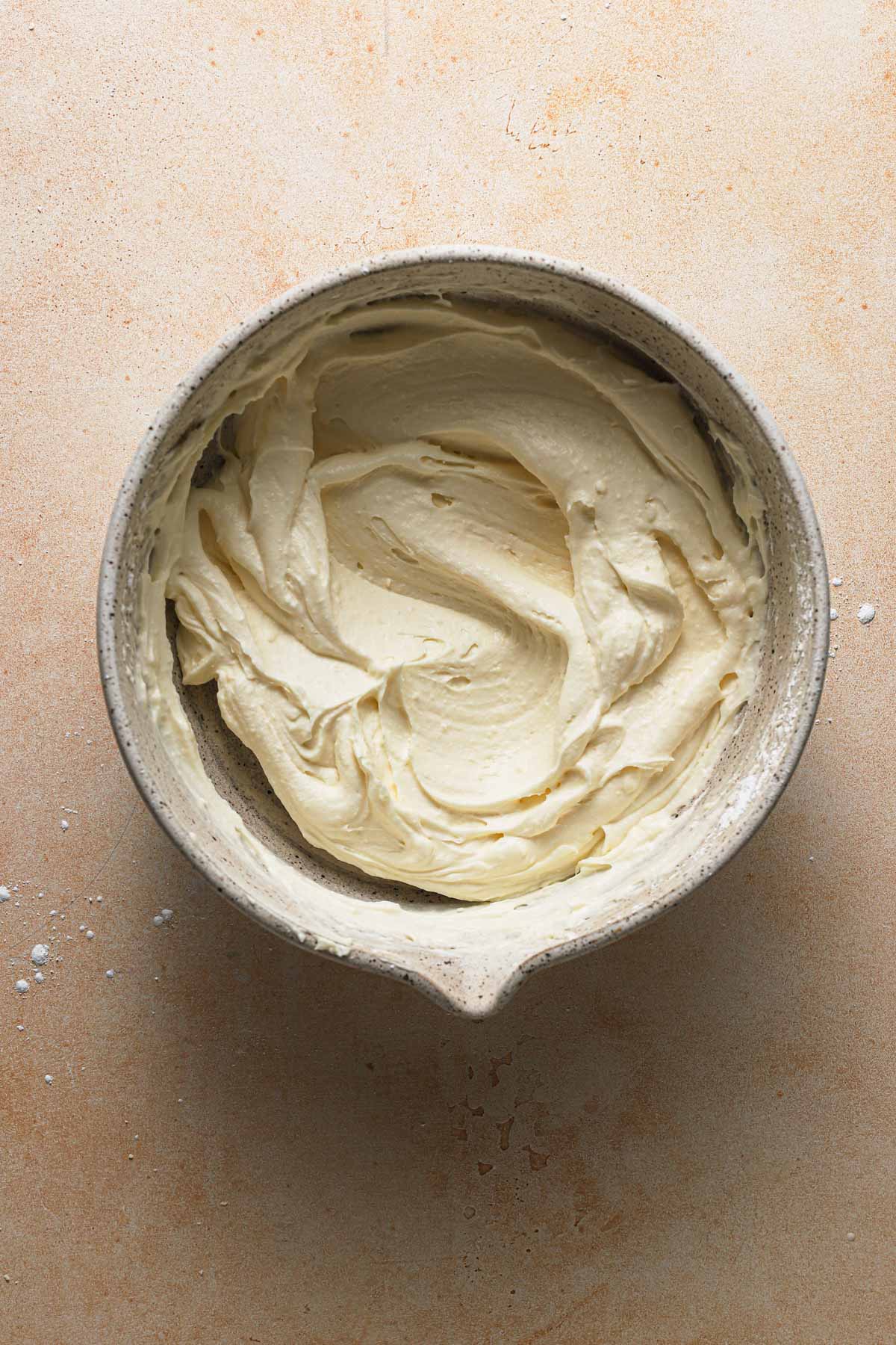 A bowl with smooth, creamy mascarpone cheese frosting.