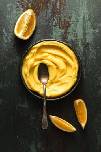 meyer lemons curd in a bowl with a spoon.
