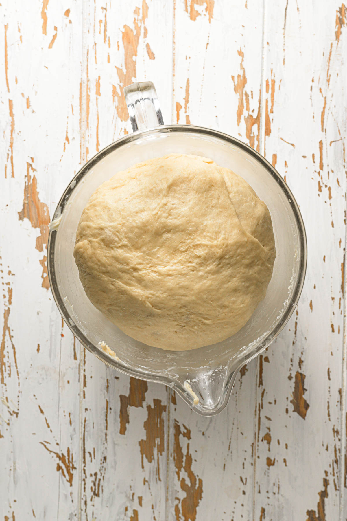 A mixer bowl with proofed dough,