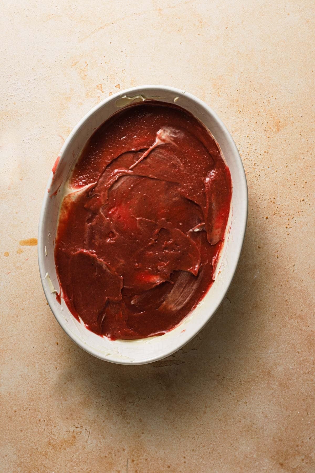 A dish with a layer of raspberry curd.