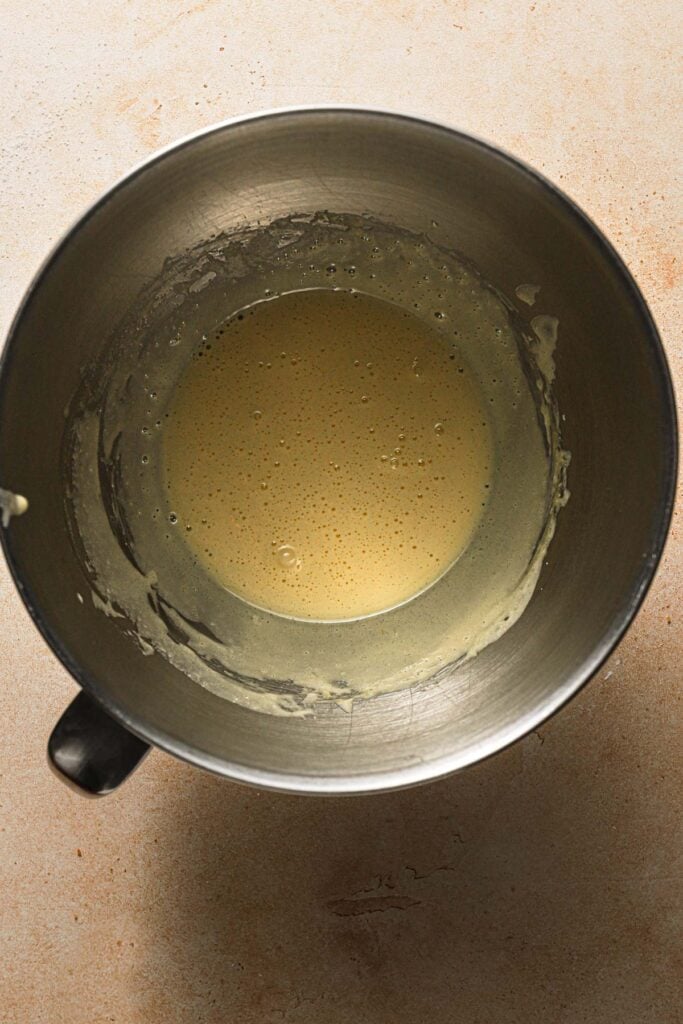 A mixing bowl with egg yolk mixture.