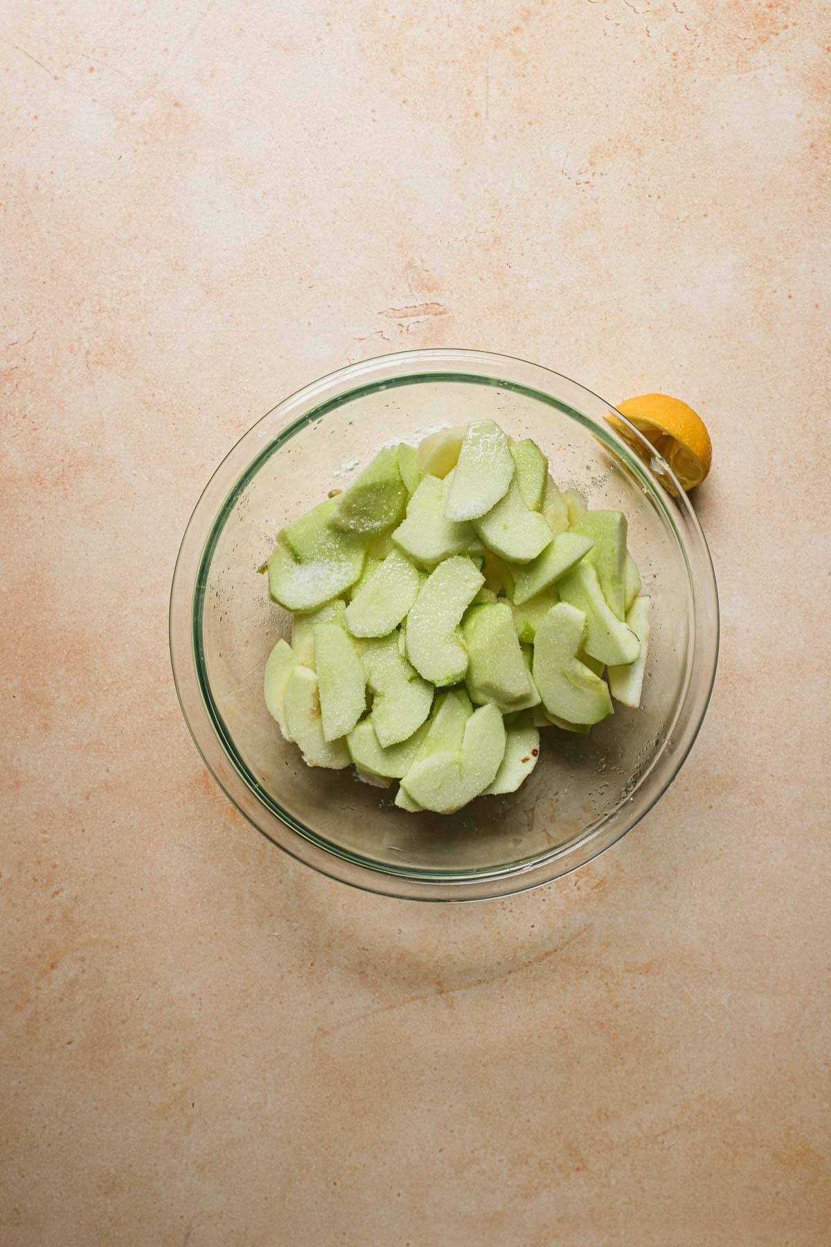 A large bowl wit sliced apples.