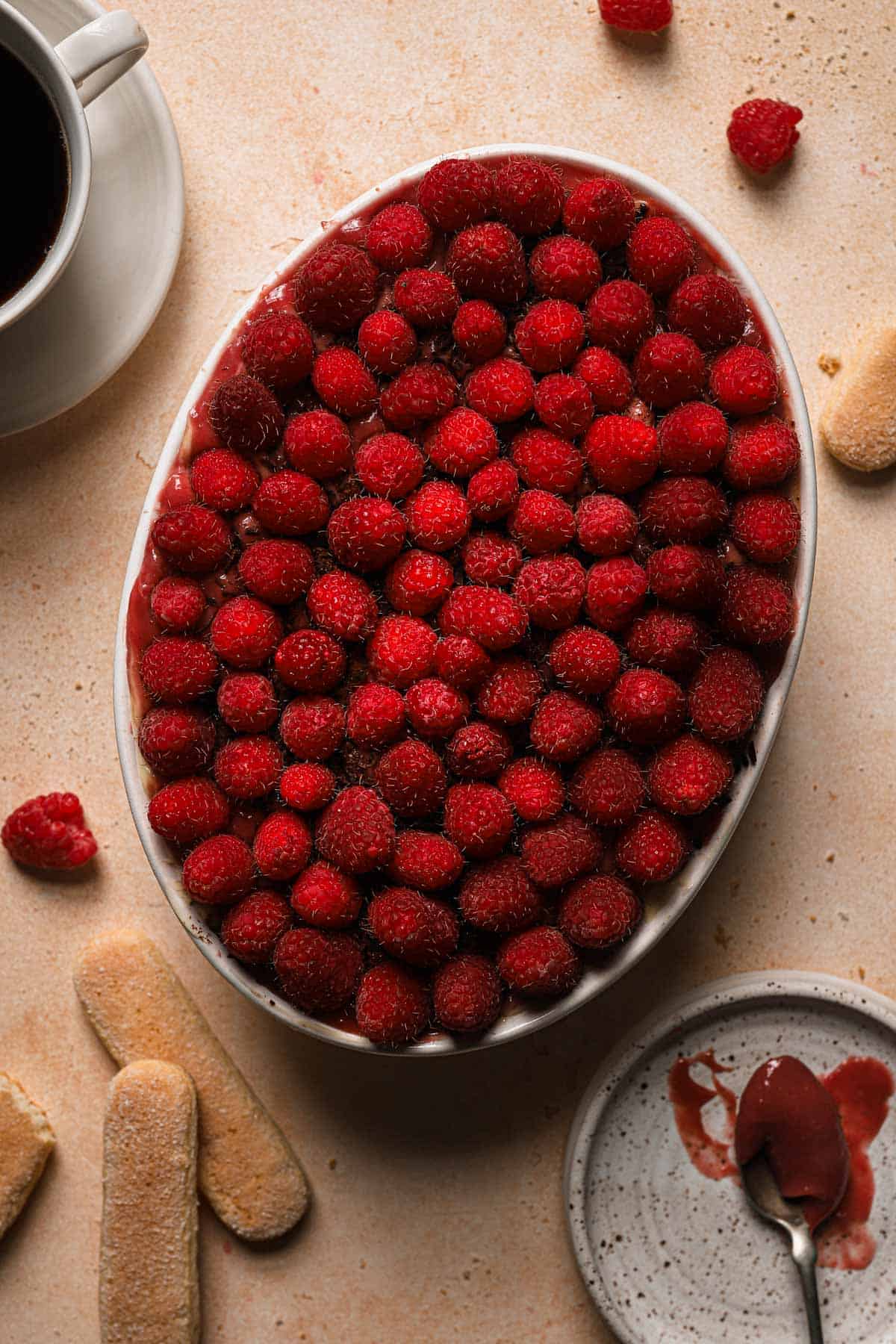 A dessert topped with fresh raspberries.