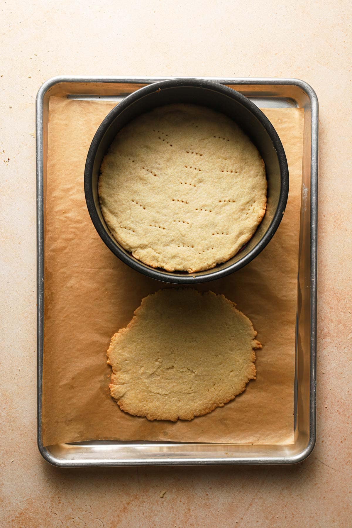 A pan with baked cookie dough in a pan and next to it.