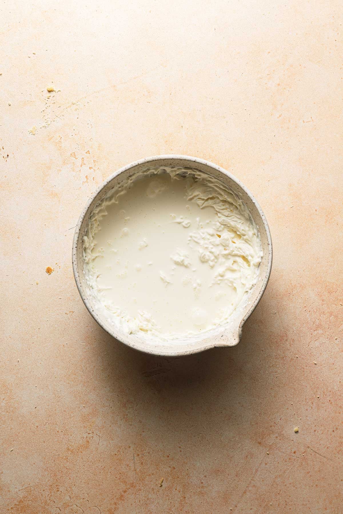 A large bowl creamed cheesed and whipped cream.