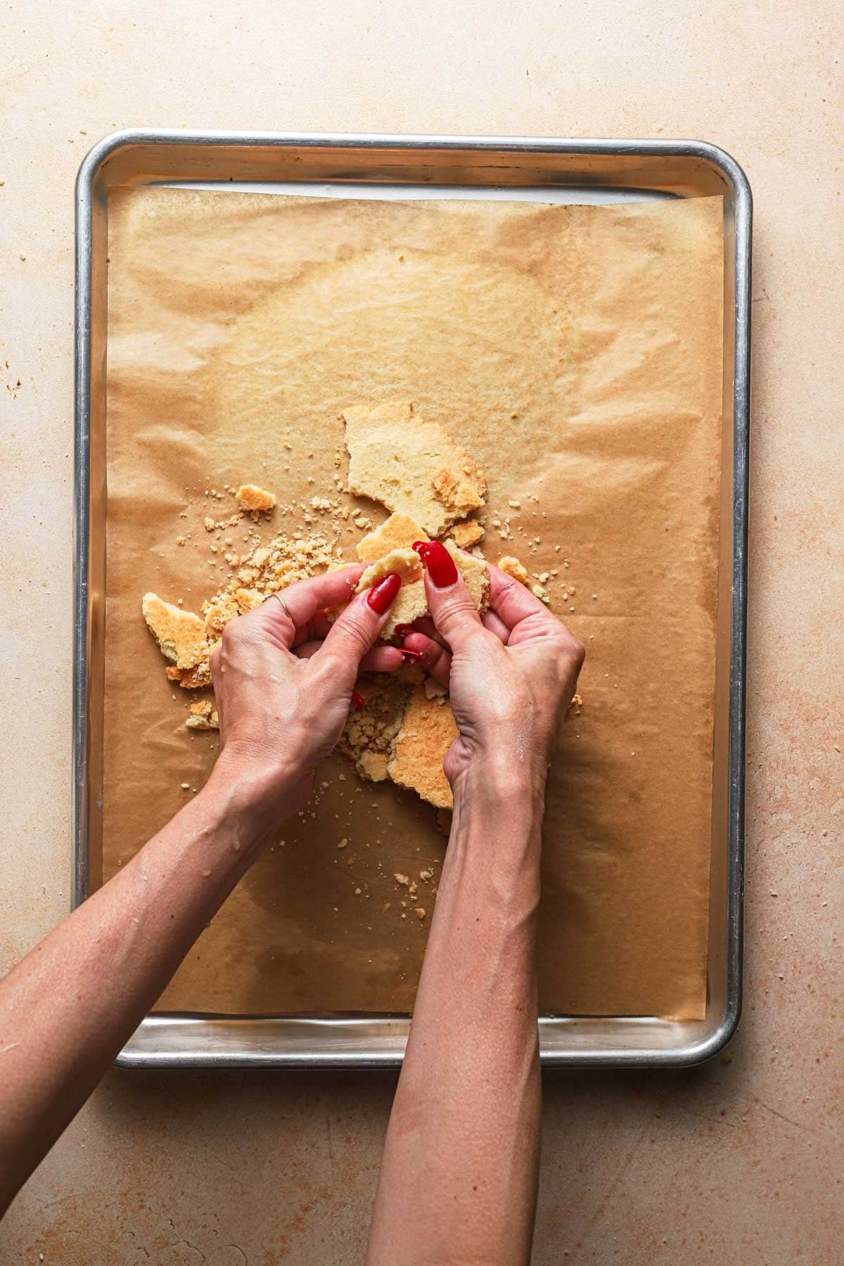 Hands crushing cookies.
