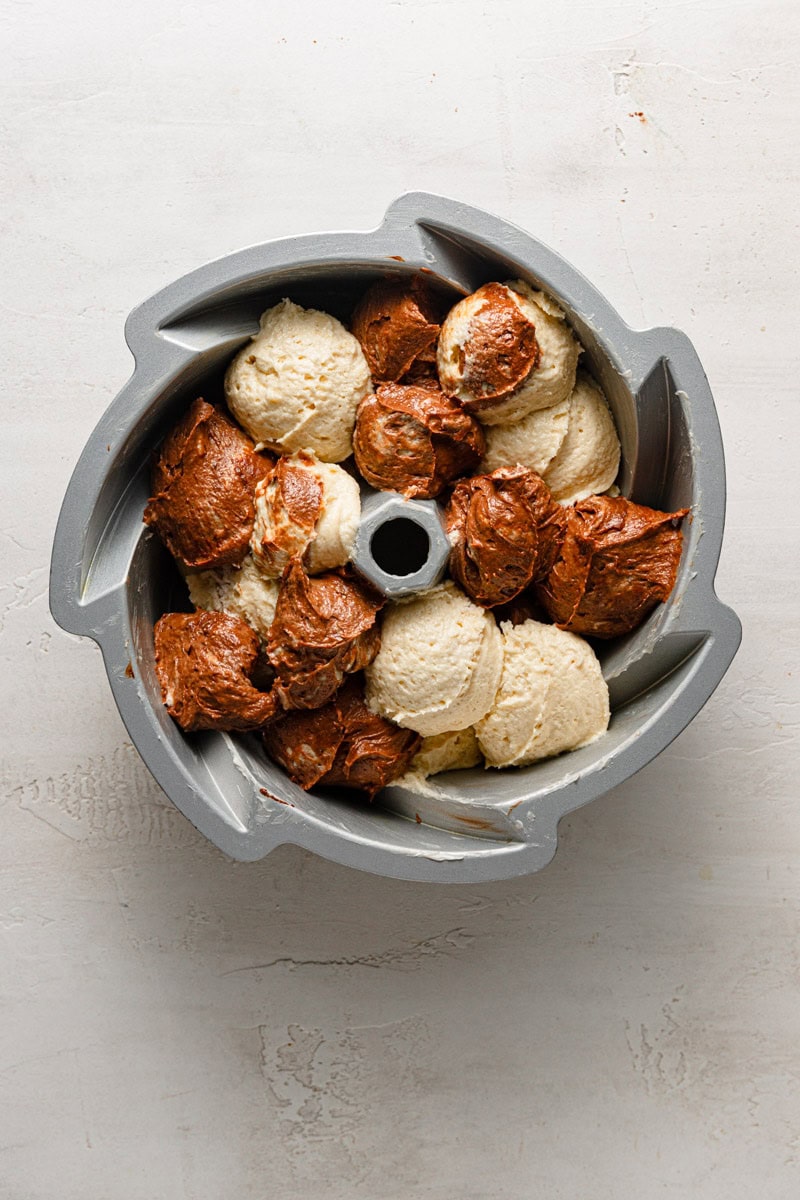 A bunt pan with marble cake batter.