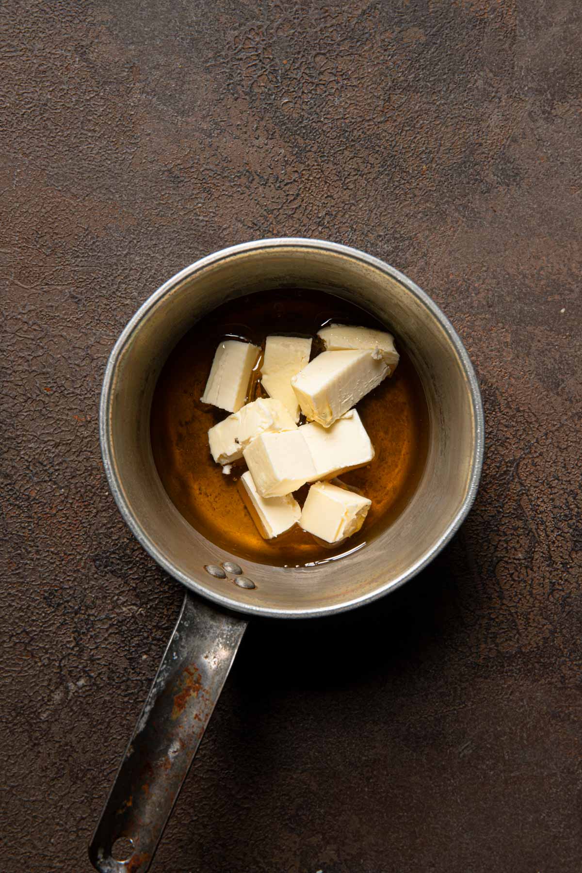 A sauce pan with honey and butter.