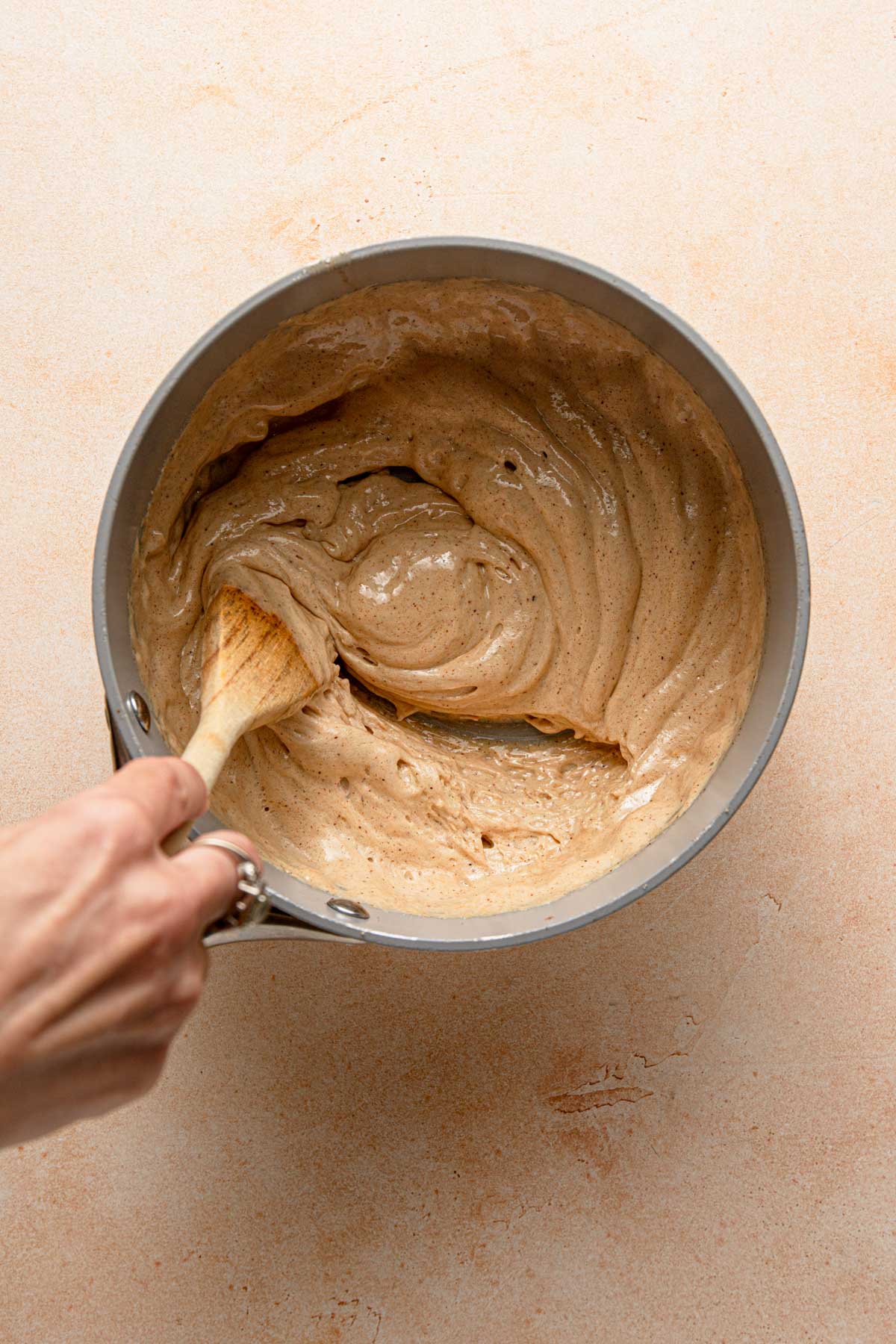 Stirring honey that is activated by baking soda.