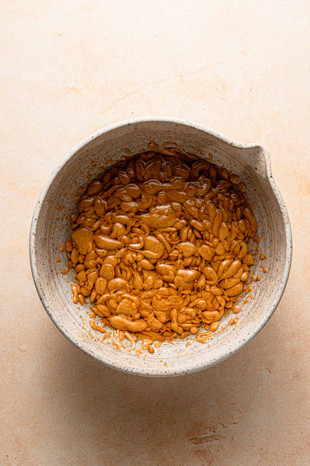 A bowl with broken honey mixture and oil.