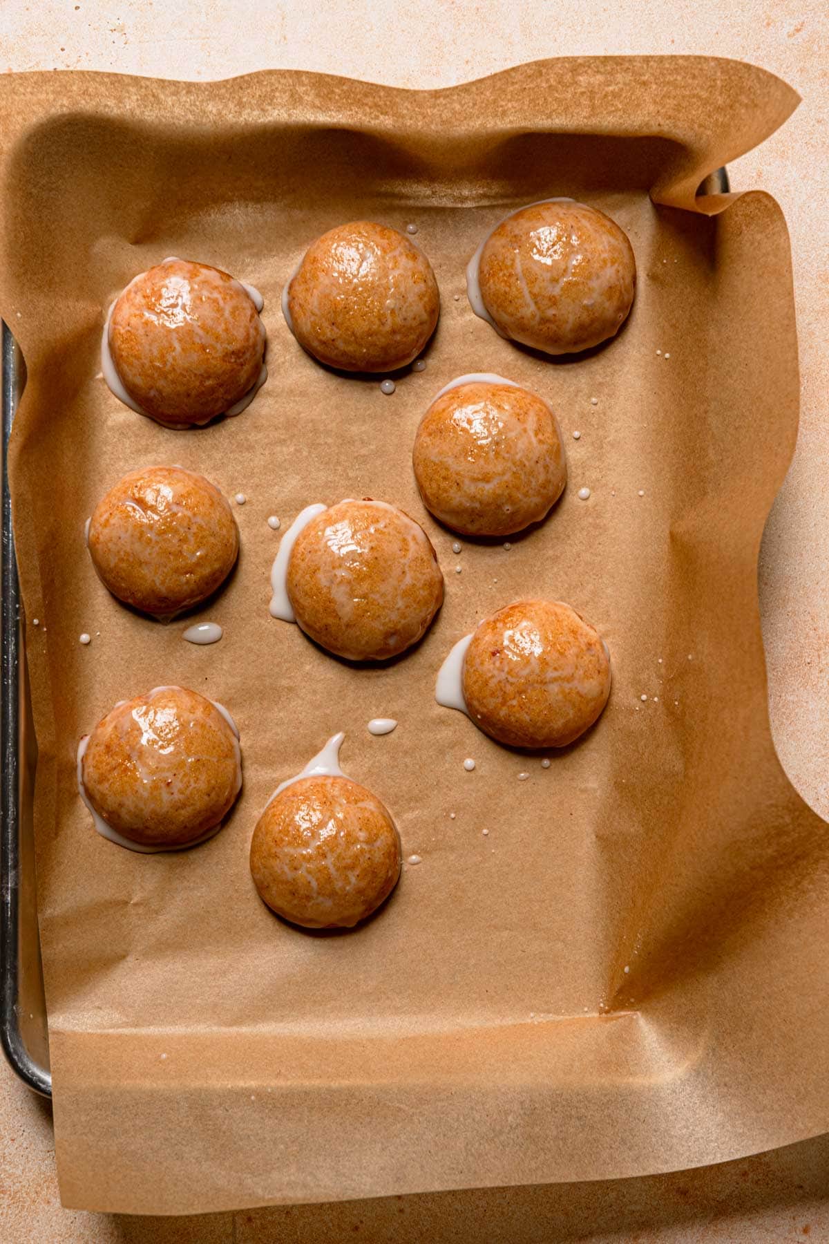 Honey cookies over a pan with parchment paper.