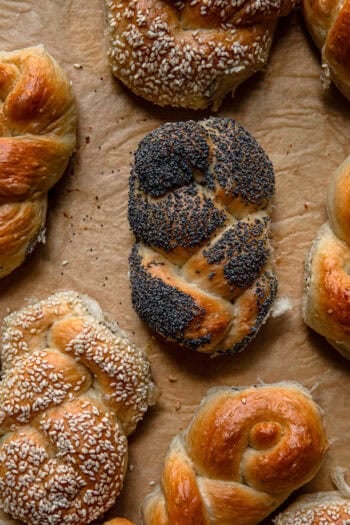 A braided roll topped with poppy seeds.