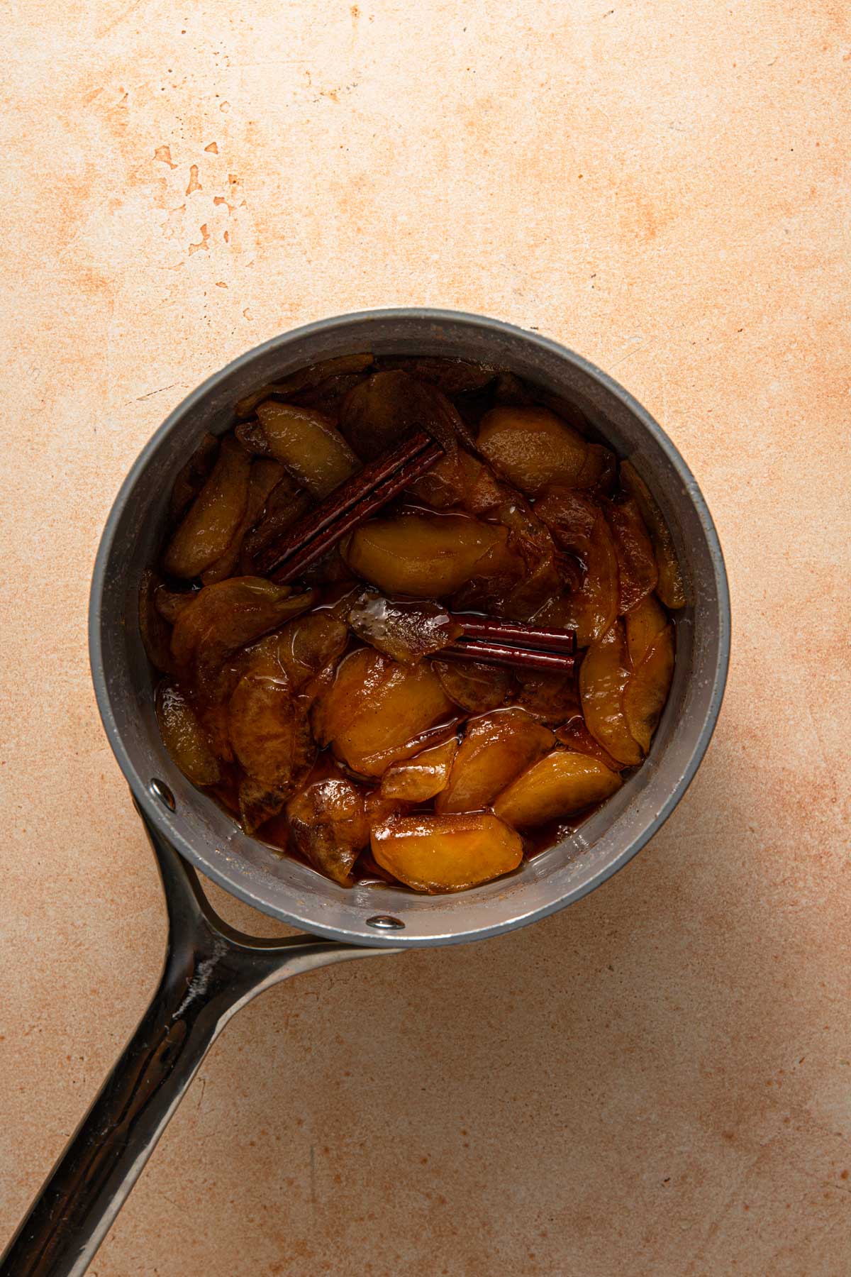 Cooked apple cinnamon in a pan.