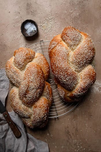 two loafs of challah with sesame seeds.
