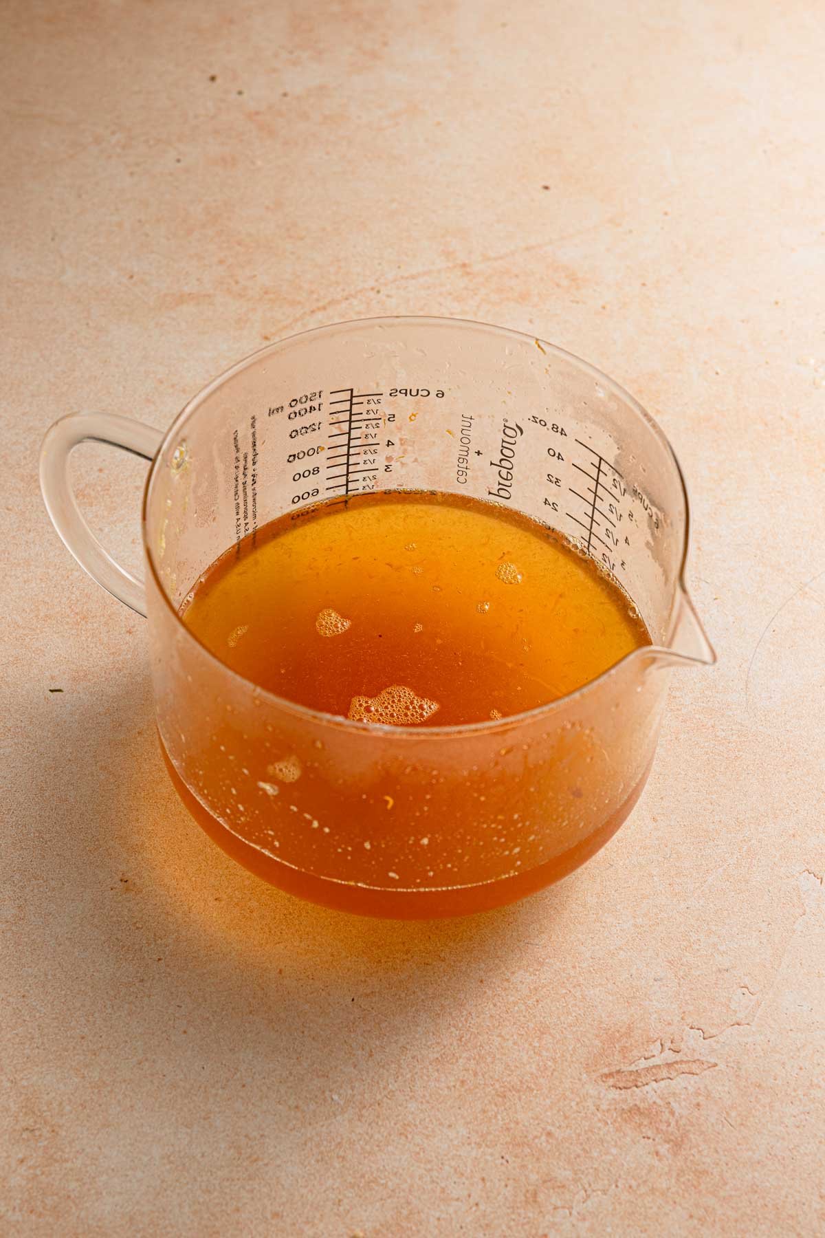 Large measuring cup with liquid syrup.