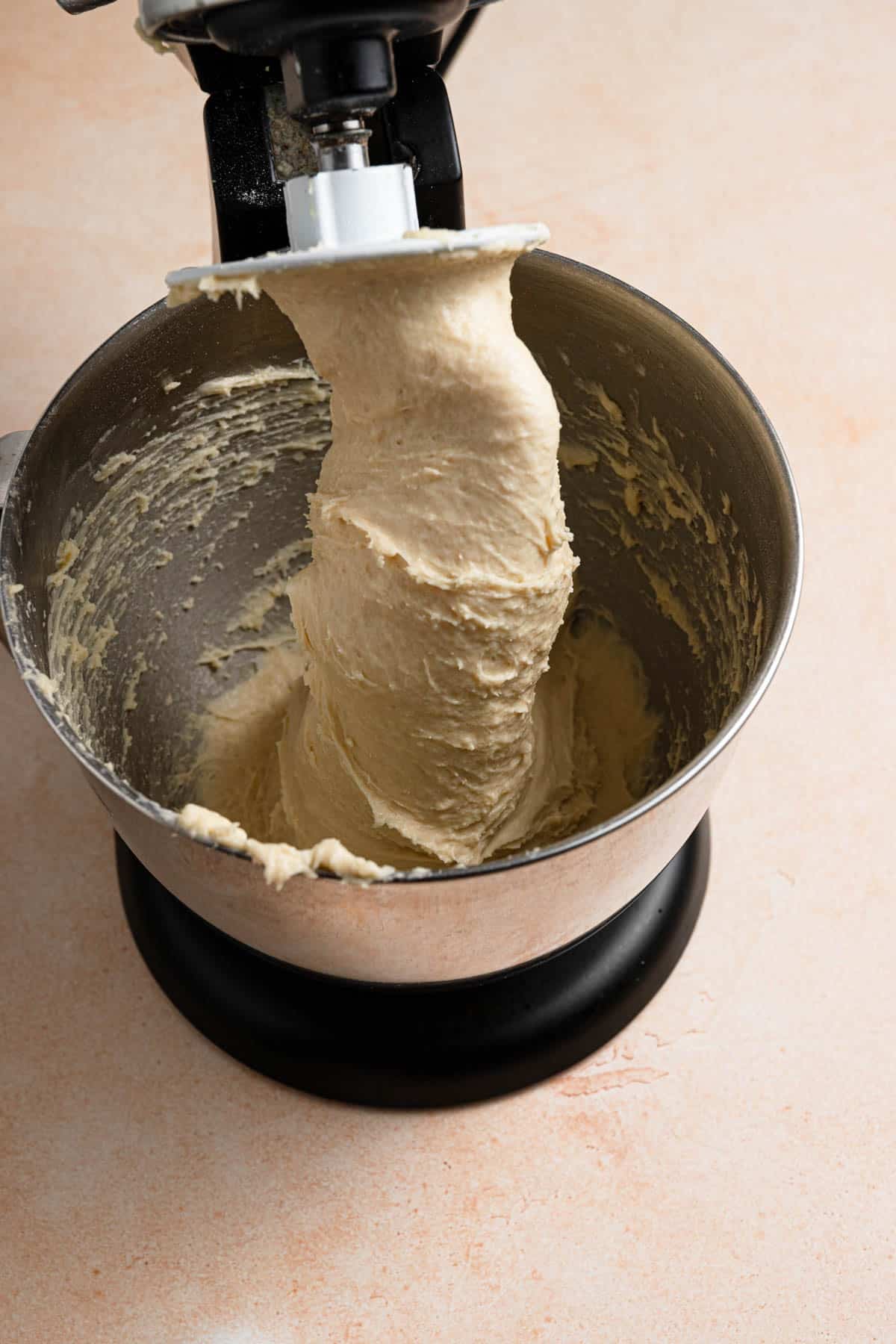 Elastic dough hanging from a dough hook.
