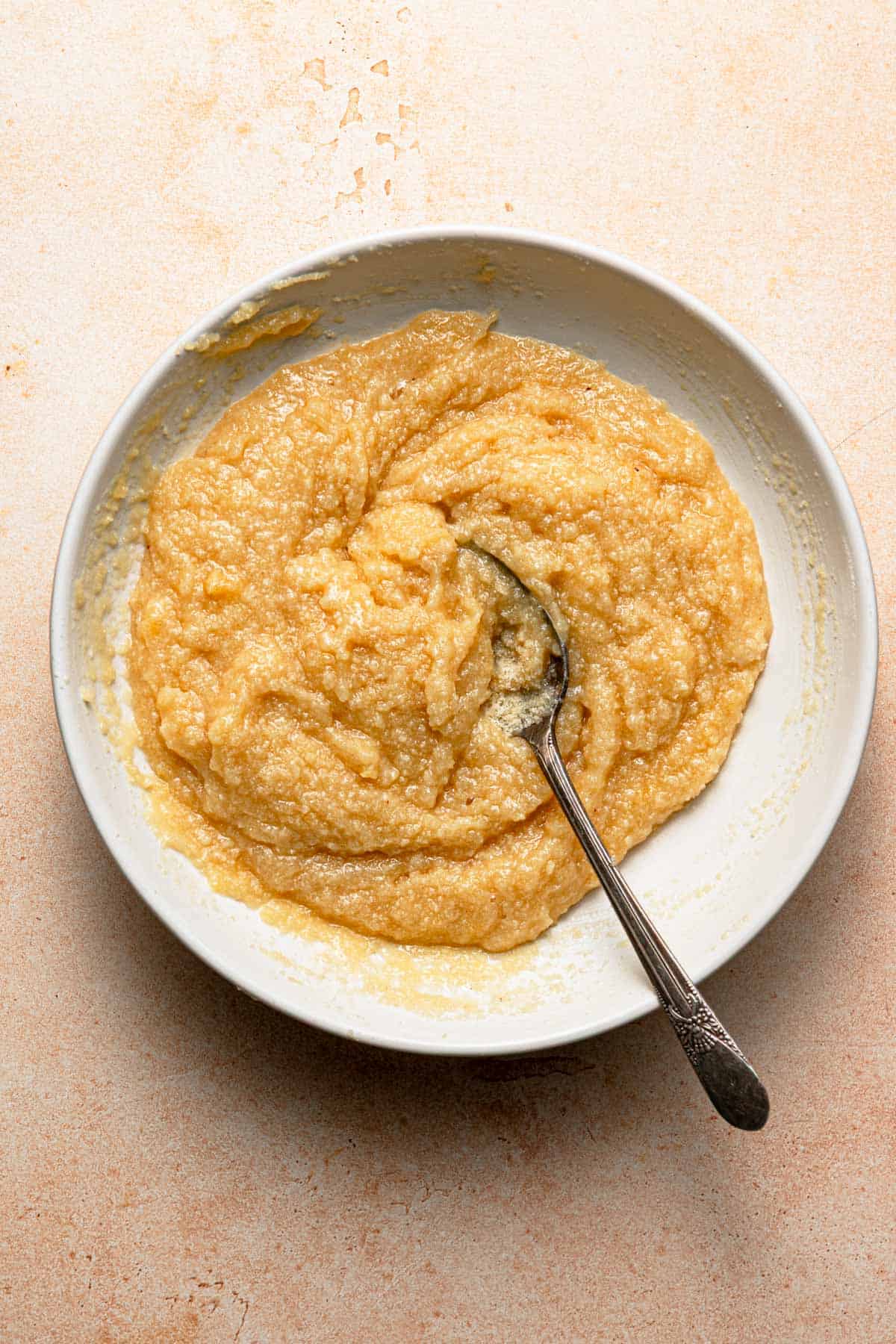 A bowl with almond cream and a spoon.