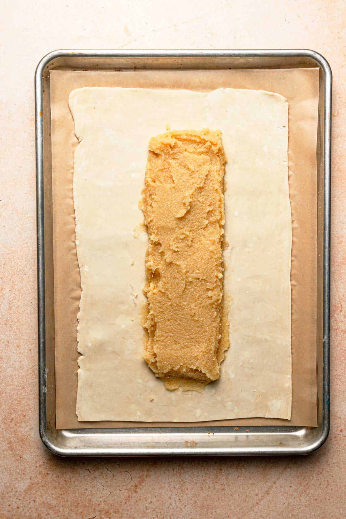 A rectangle dough topped with almond cream.