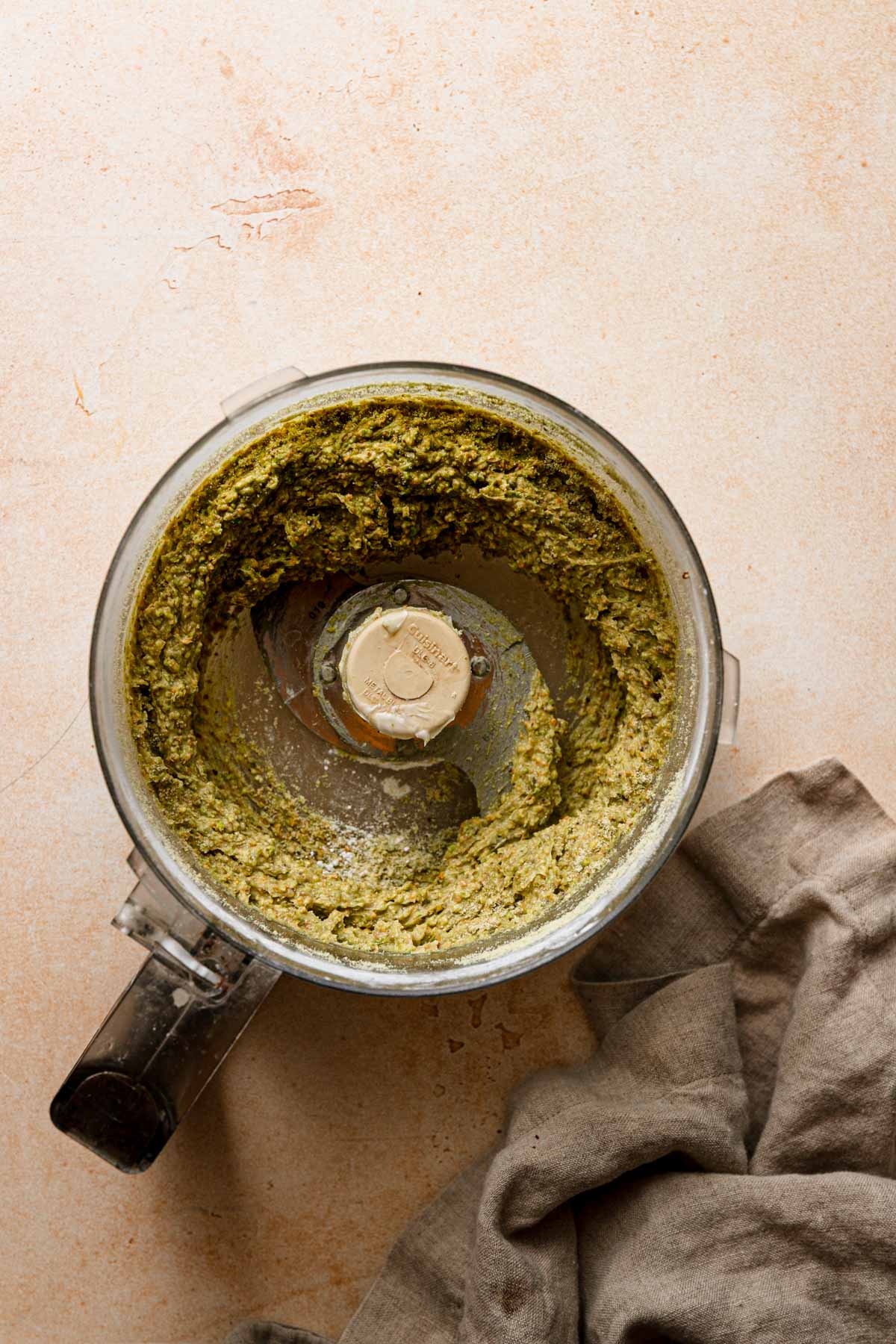 A bowl of a food processor processed cream. A napkin next to it.