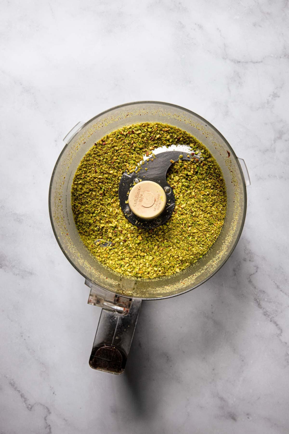 A food professor bowl with ground pistachios.