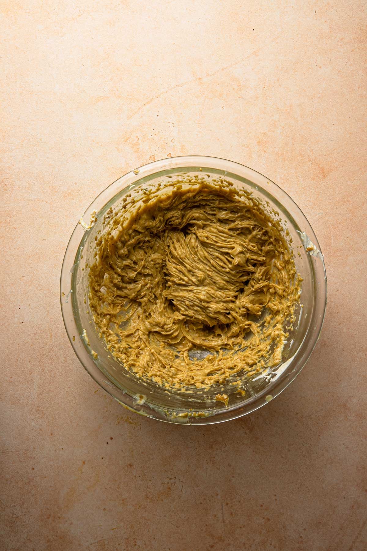 A glass bowl with pistachio mascarpone cream.