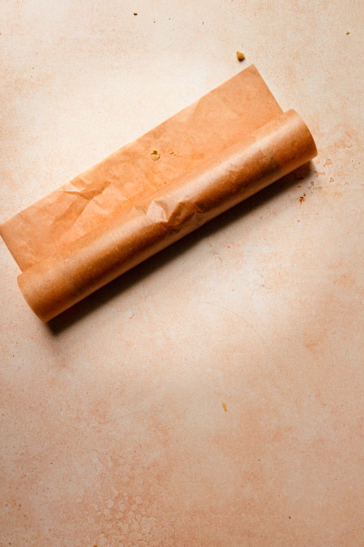 Rolled cookie dough in parchment paper.