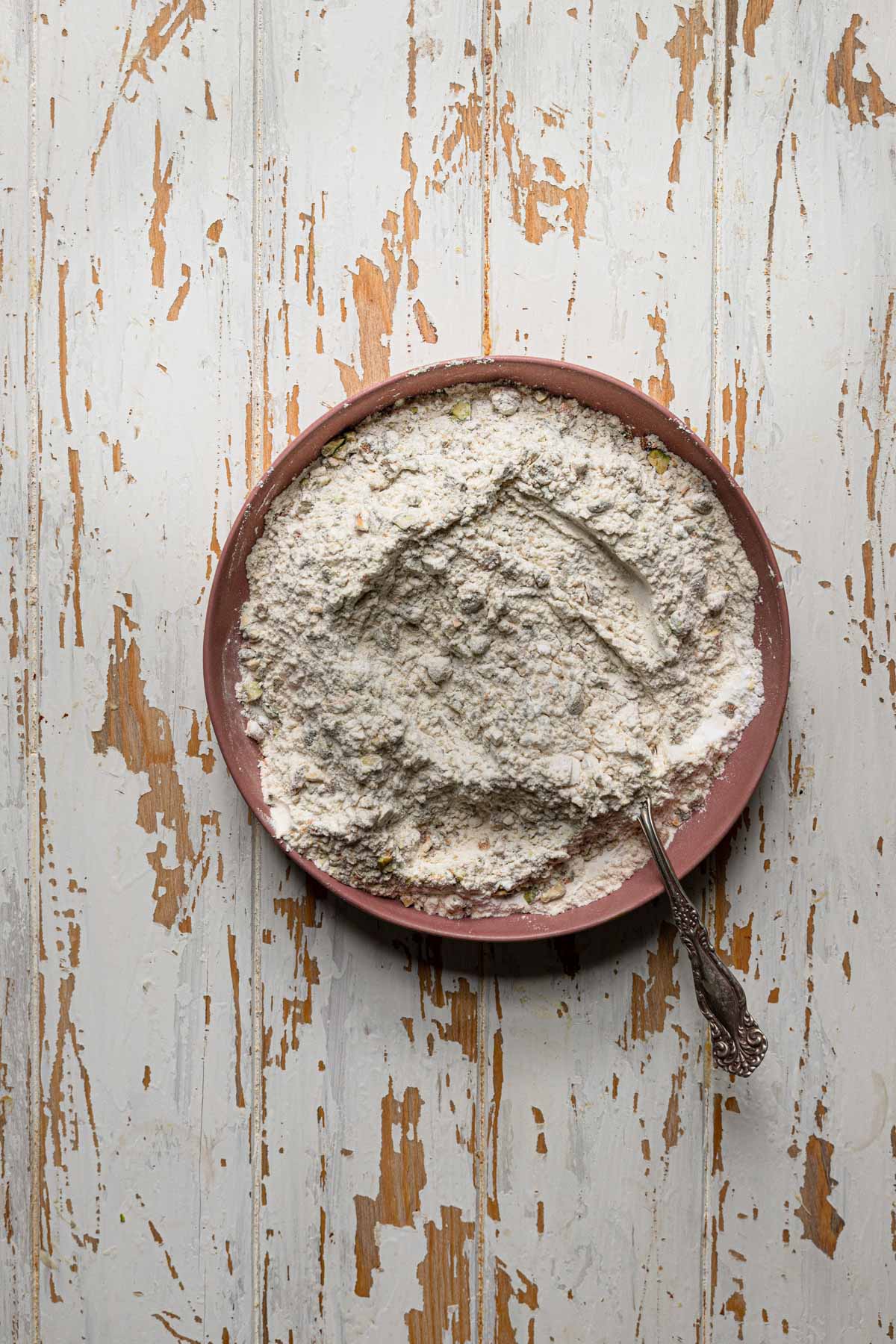 A bowl with flour and a fork.