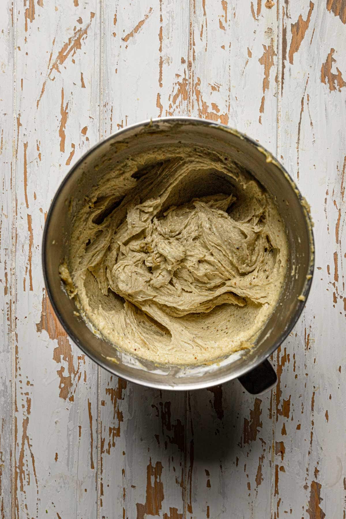 A stand mixer bowl with cake batter.