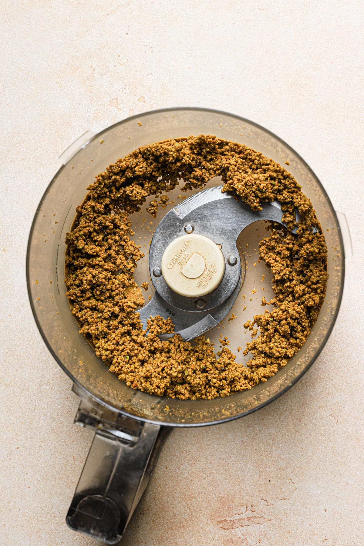 Process half of the pistachio in a food processor until moist and paste like.