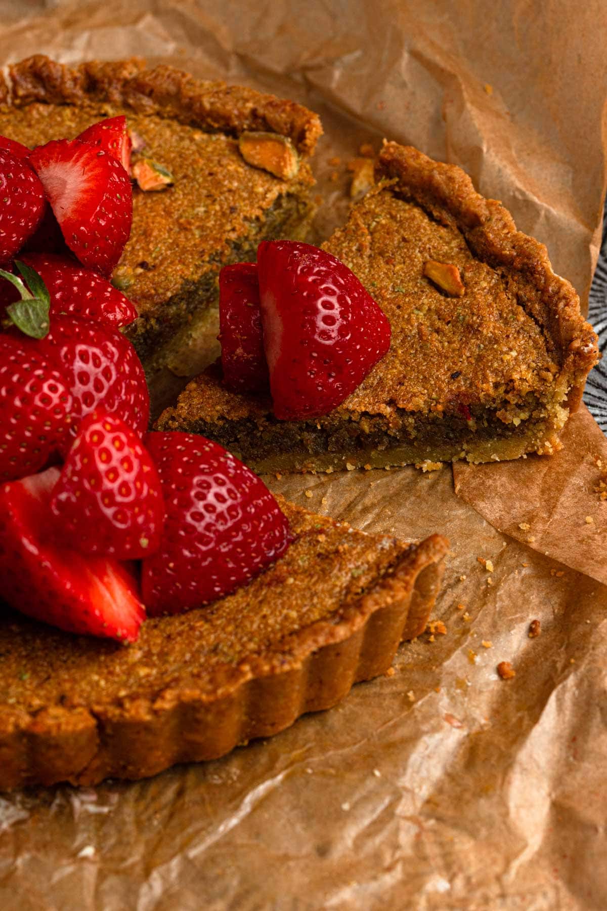 Pistachio cream tart topped with fresh strawberries.