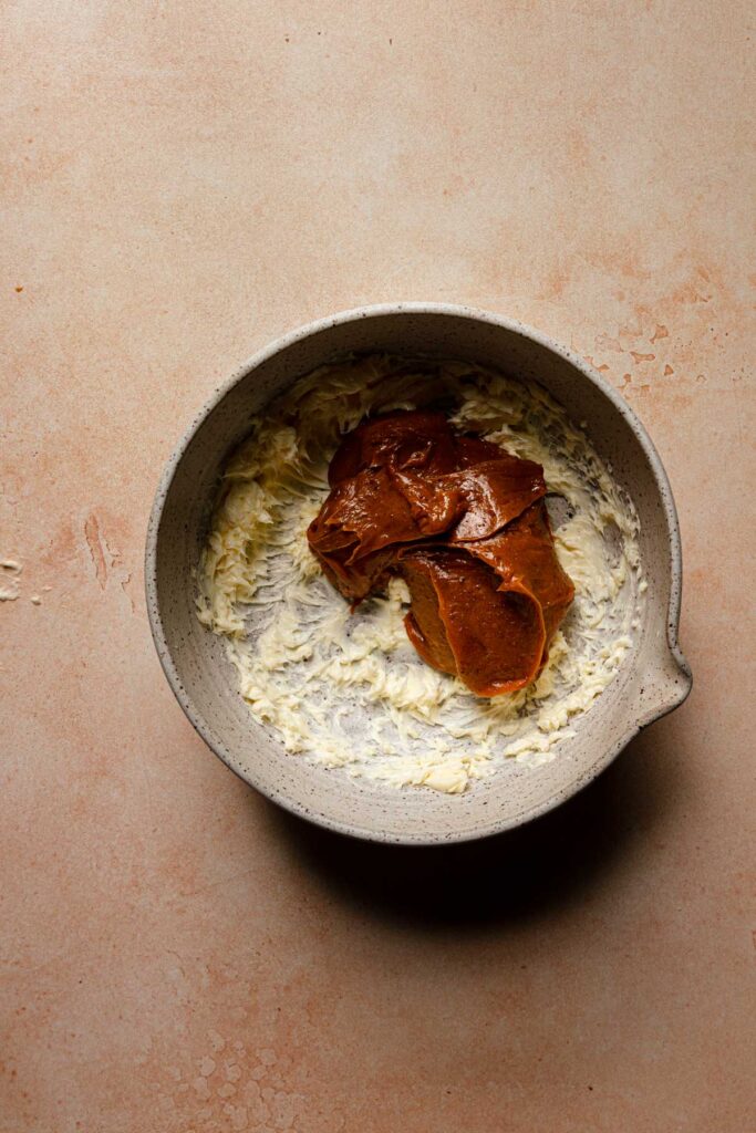 A large bowl with whipped butter and pistachio caramel.