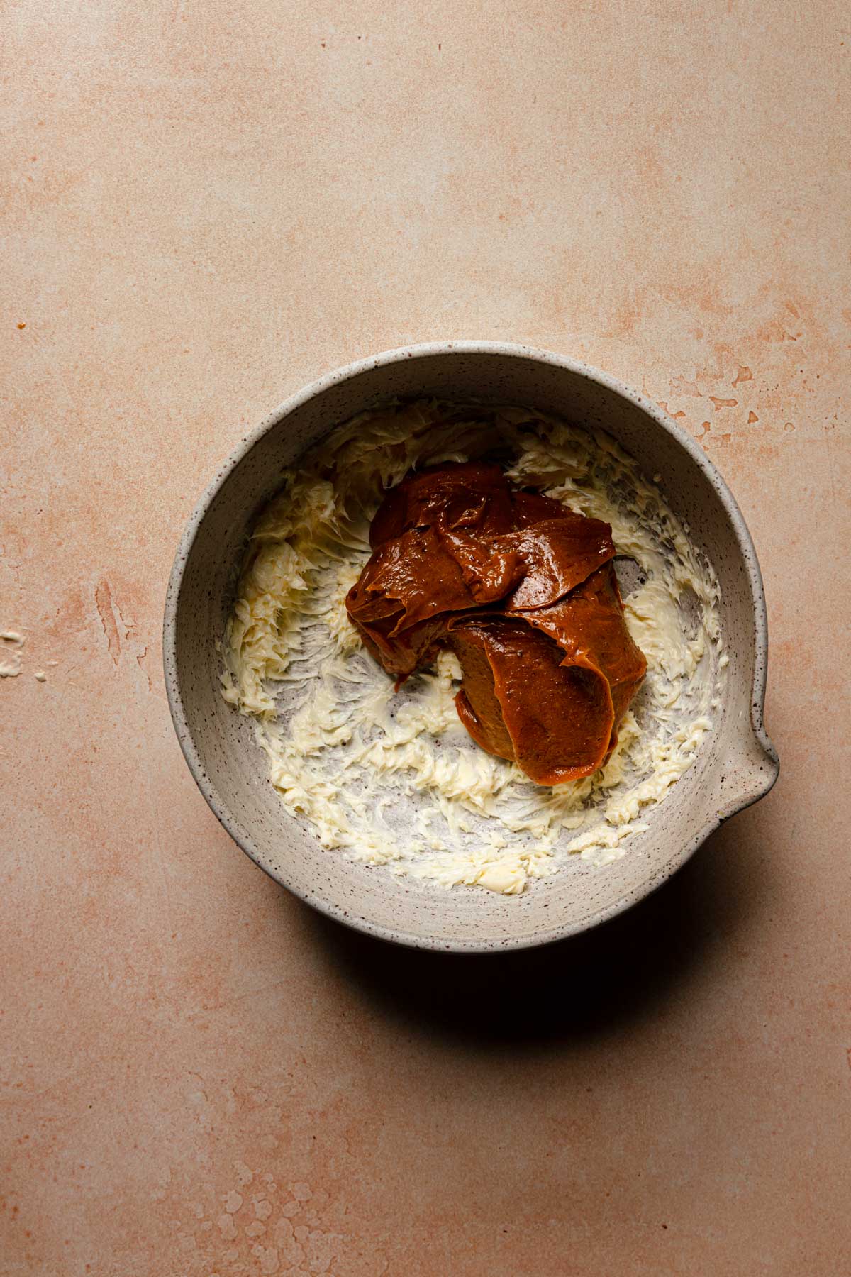 A large bowl with whipped butter and pistachio caramel.