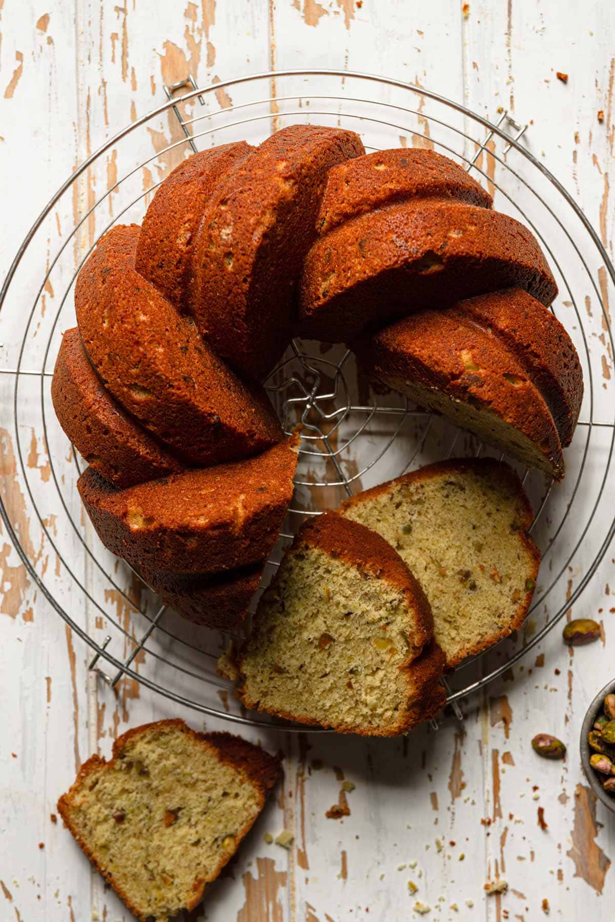 Pistachio bundt cake on a cooling rack.