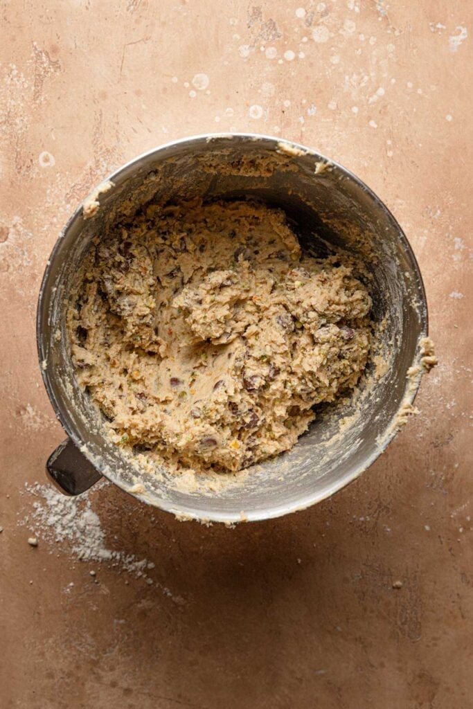 A mixing bowl with chocolate chip pistachio cookie dough.