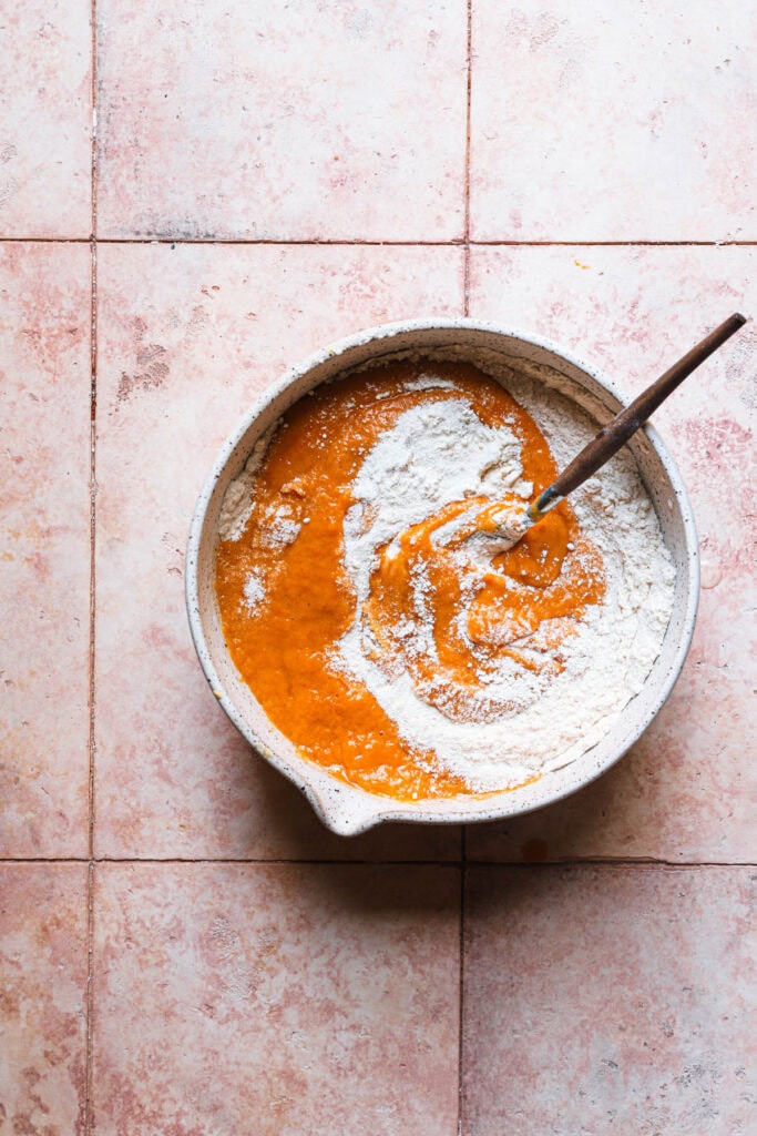 A bowl with pumpkin donuts mixture.