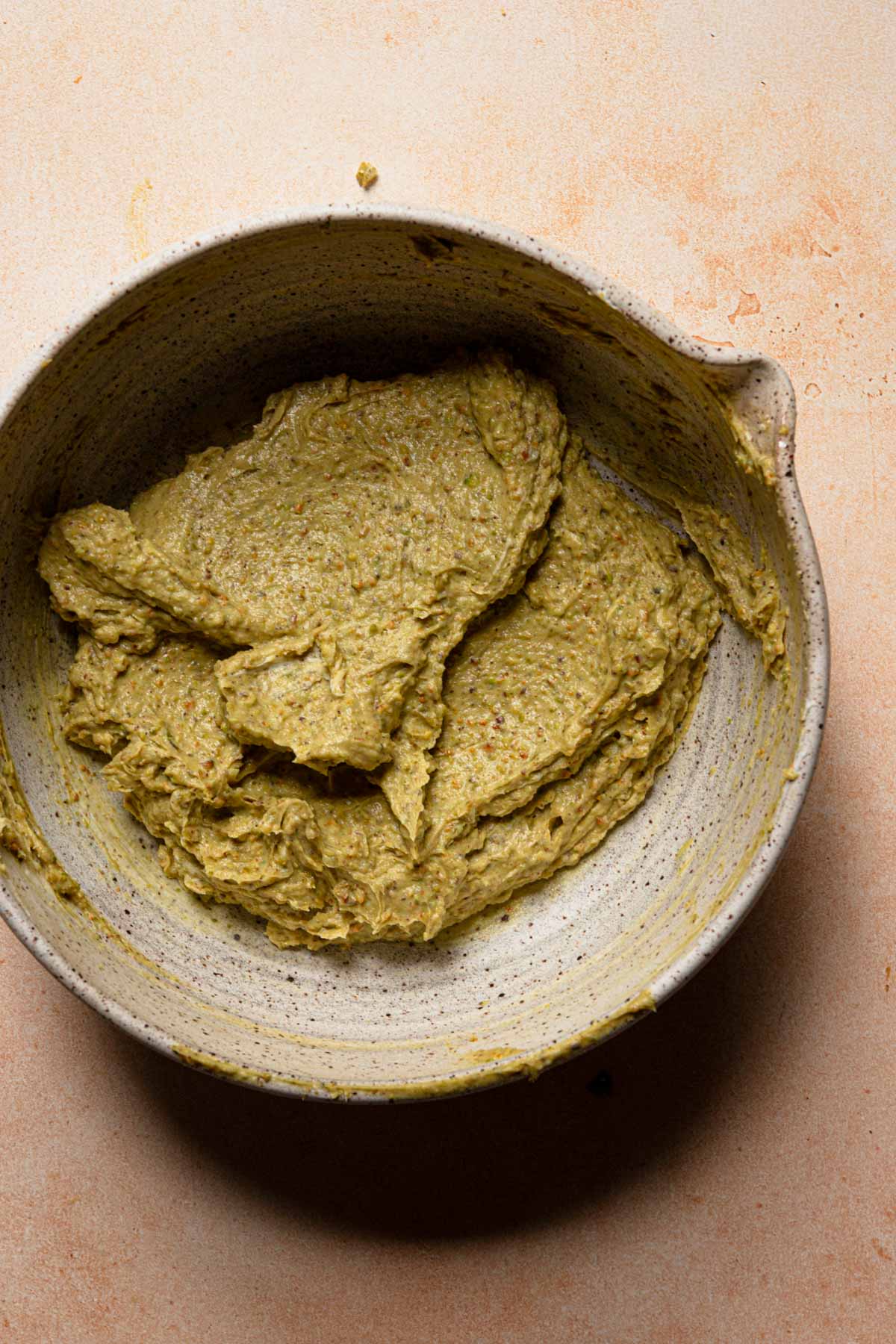 a large bowl with a green creamy mixture in it.