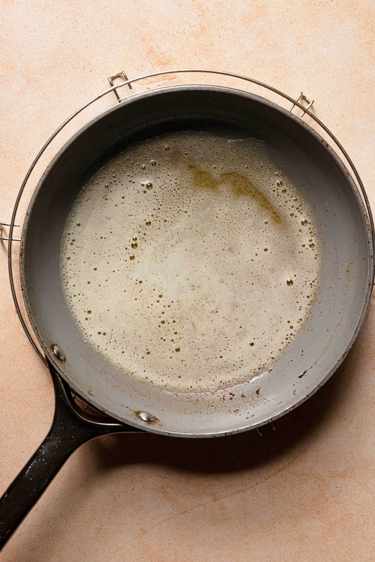 A skillet with melted butter.
