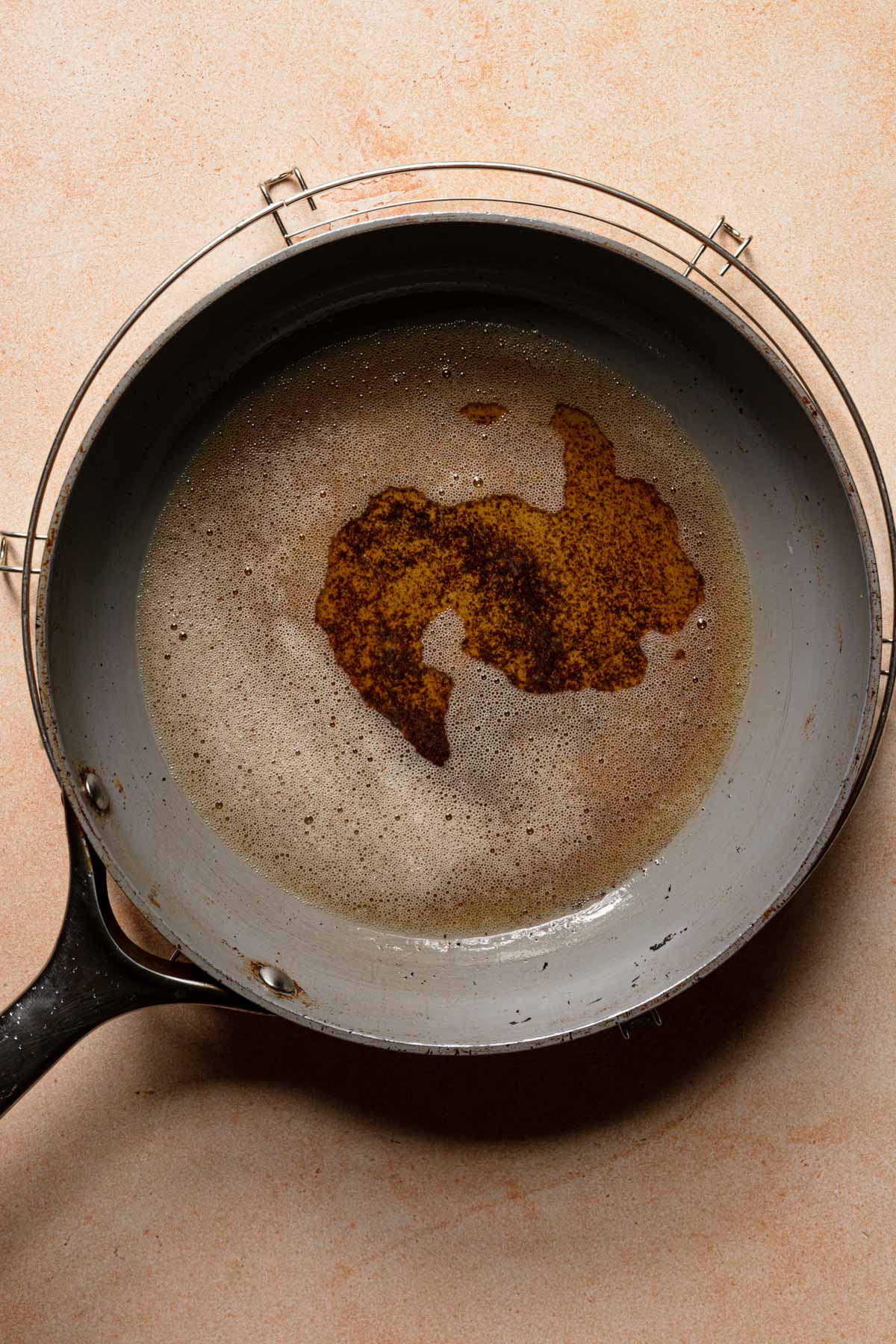 A skillet with melted brown butter.