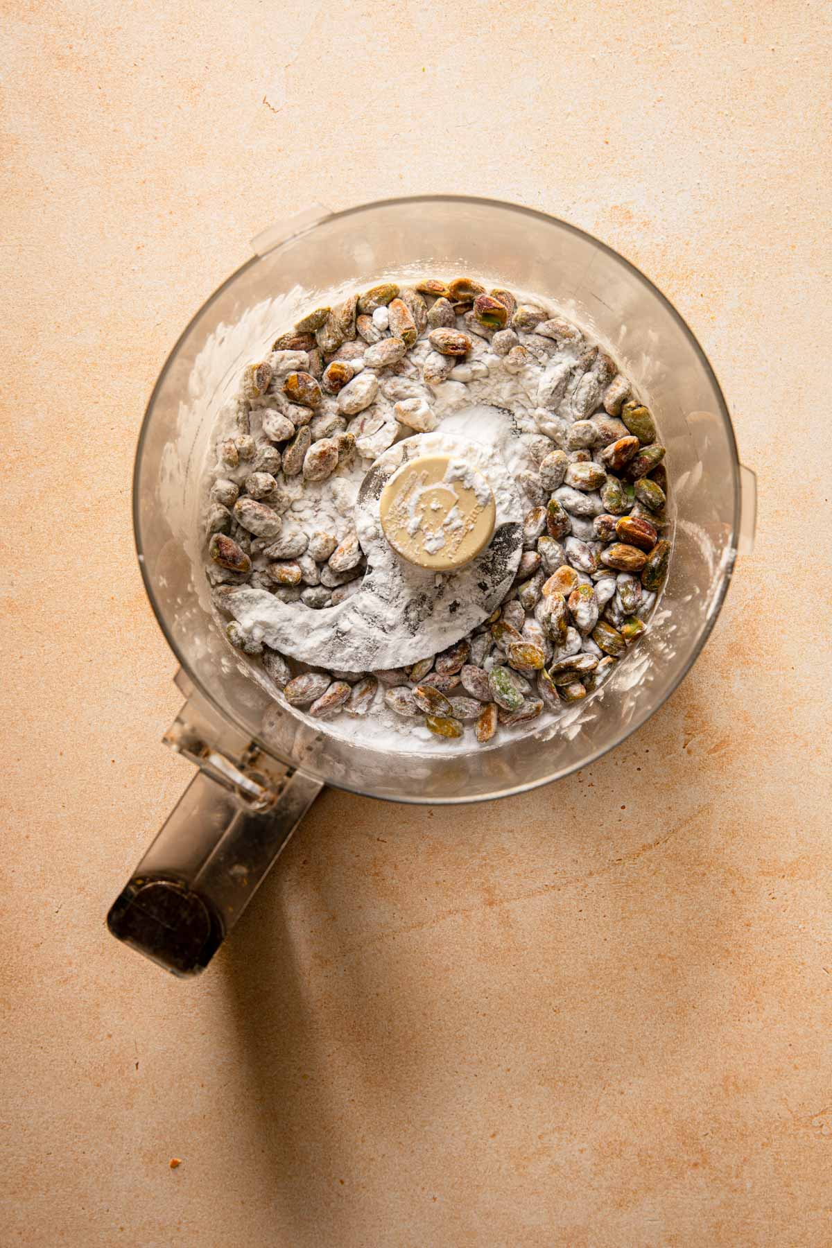 A food processor with pistachio and potato starch.