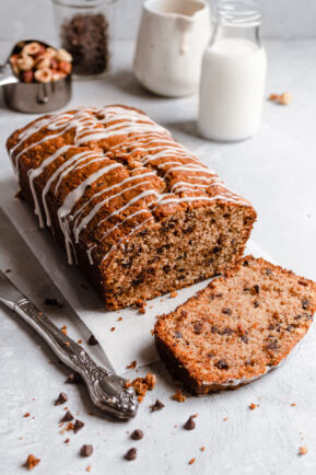 Sliced chocolate chip hazelnut quick bread with icing.