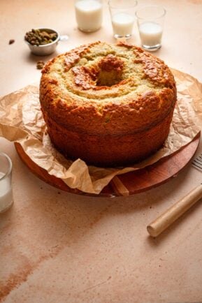 Chiffon cake on a late with milk cups around it.