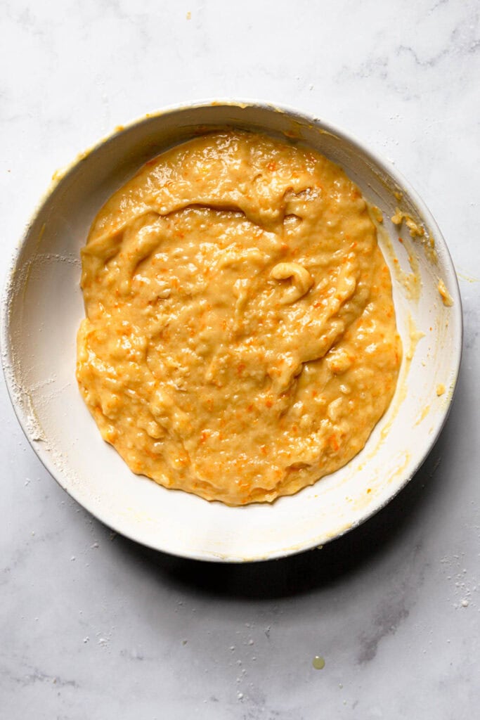 A bowl with citrus muffin batter.