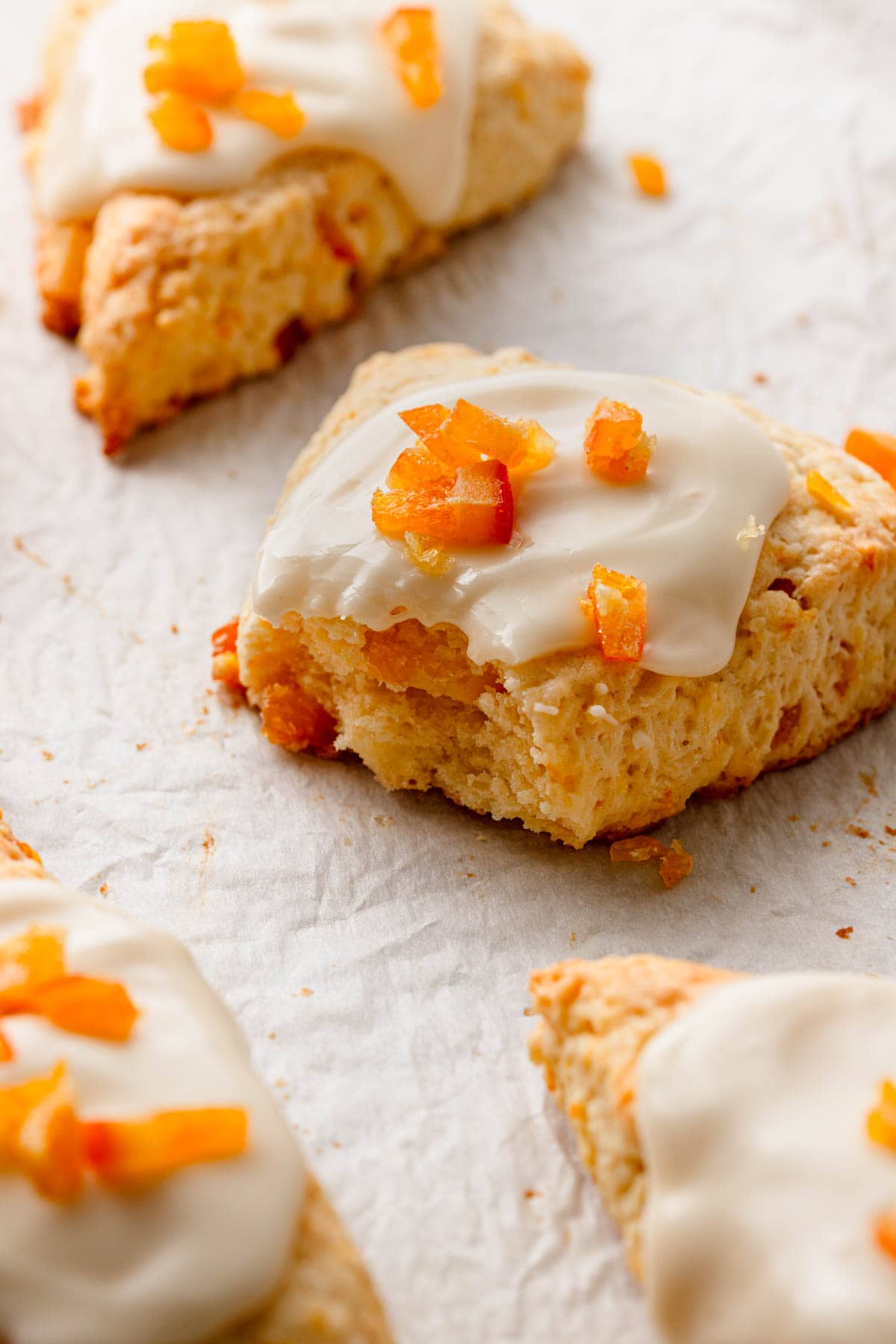 orange cream cheese scones glazed and topped with chopped candied oranges.