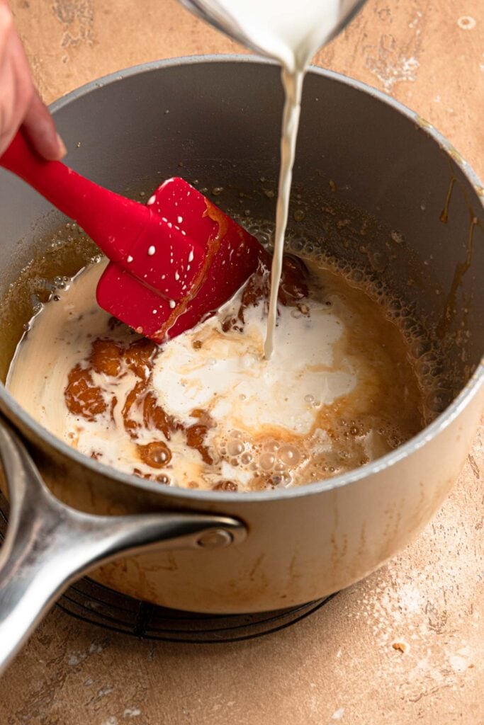 Pouring cream into a caramel.
