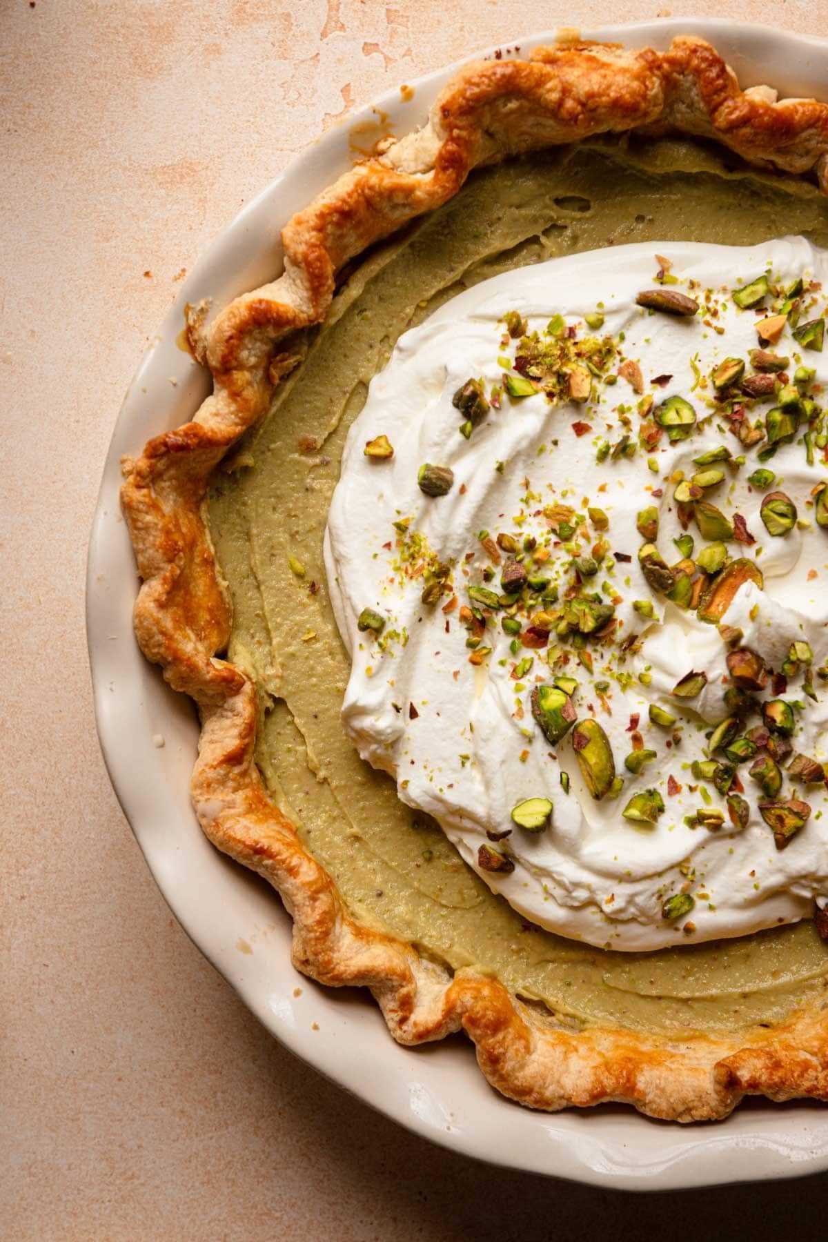 Pistachio cream pie topped with whipped cream and chopped pistachios.
